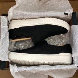 Black slip-on sneakers; faux snakeskin